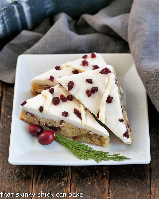 3 cranberry bars on a square white plate