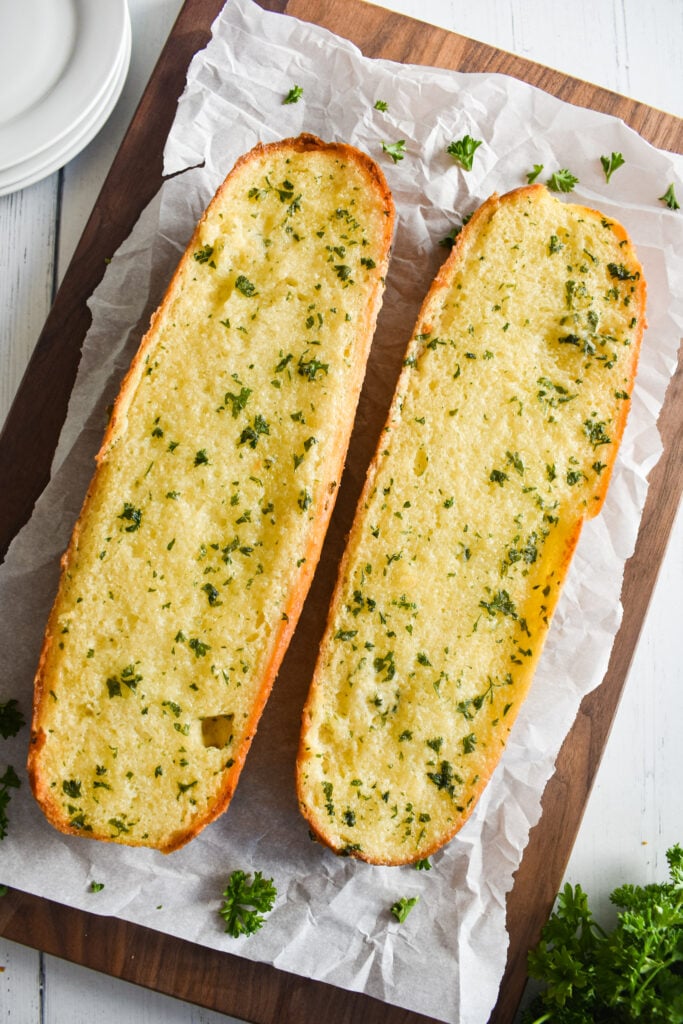 two baked garlic bread loaves 