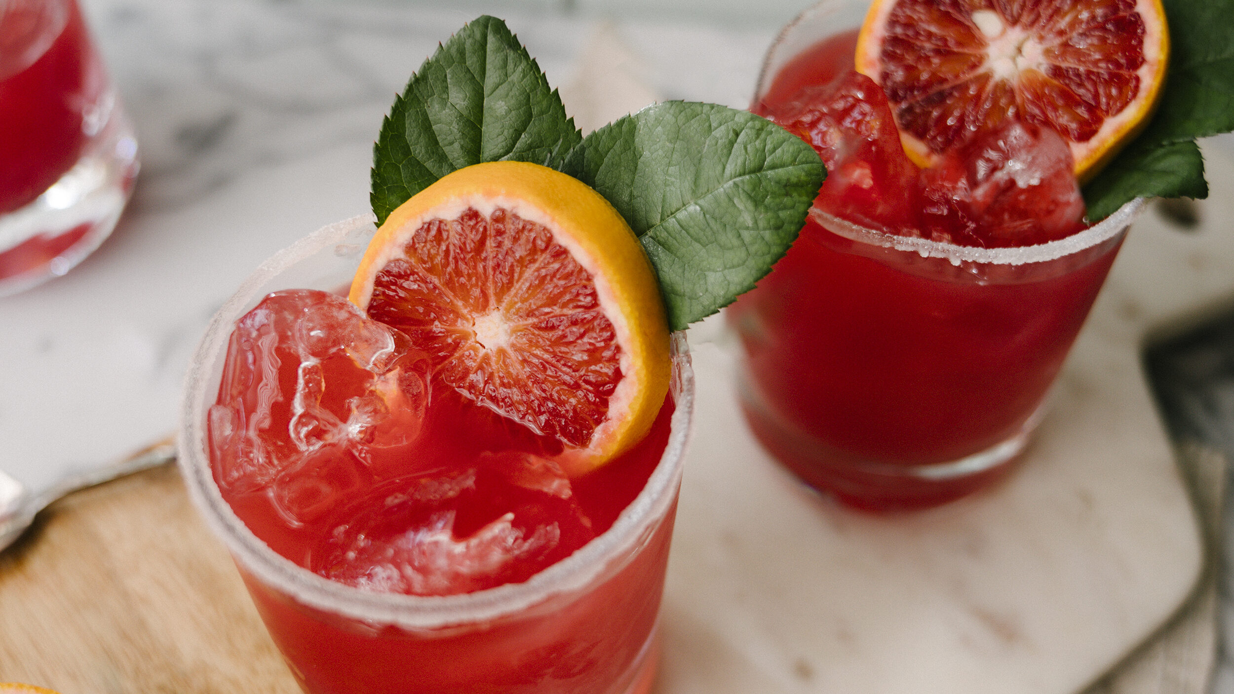 two cocktails with grapefruit garnish