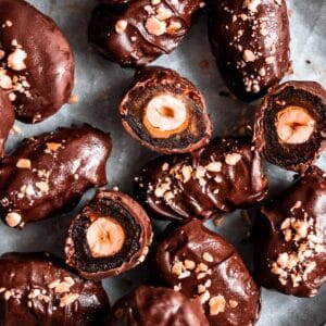 chocolate dates on a white parchment paper.