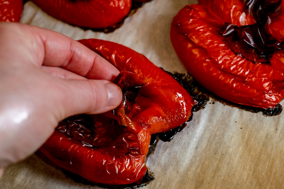 peeling skin off roasted red pepper.
