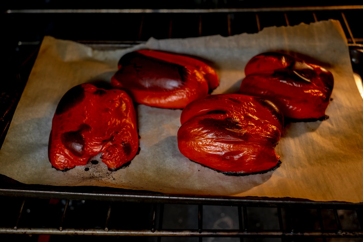 red bell peppers roasting in oven.