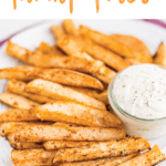 A white plate of turnip fries and a jar of ranch dip on top of a purple napkin. Text "Baked Turnip Fries" is written at the top of the image.