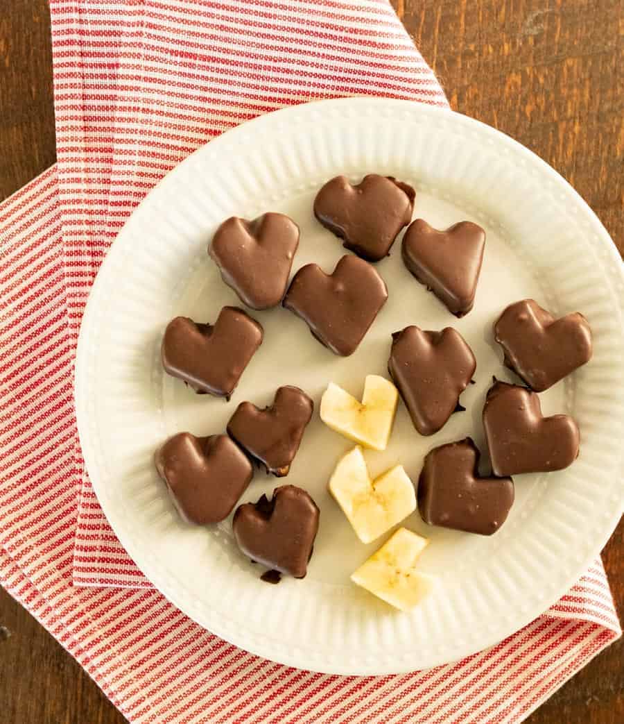 Chocolate covered banana hearts made with only two ingredients and are a great treats for kids to help make and eat.