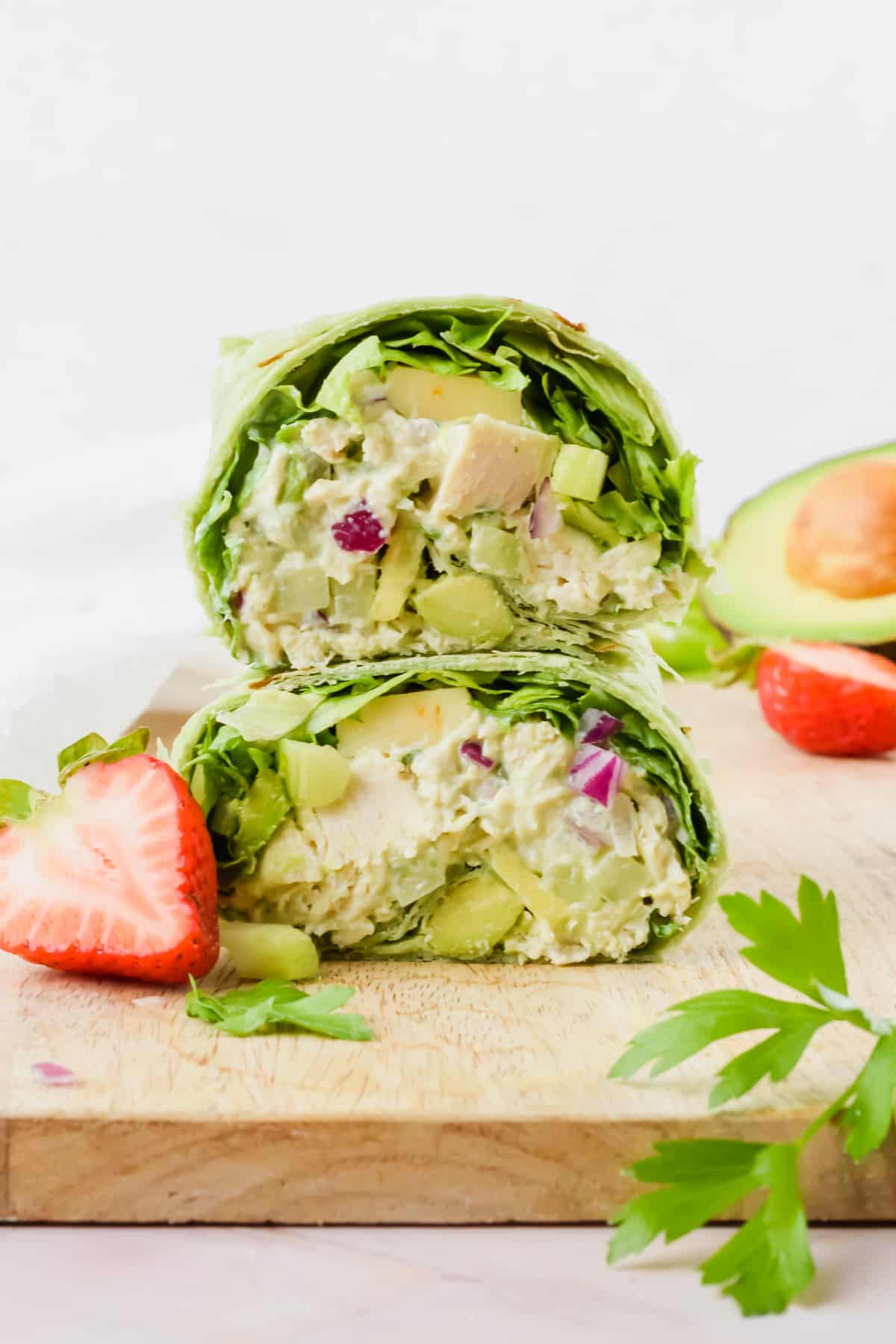 Avocado greek yogurt chicken salad with greens in a wrap