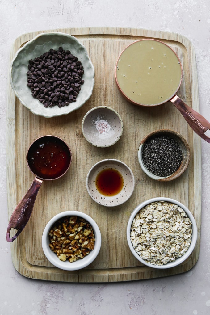 Small bowls of recipe ingredients on a wood cutting board.