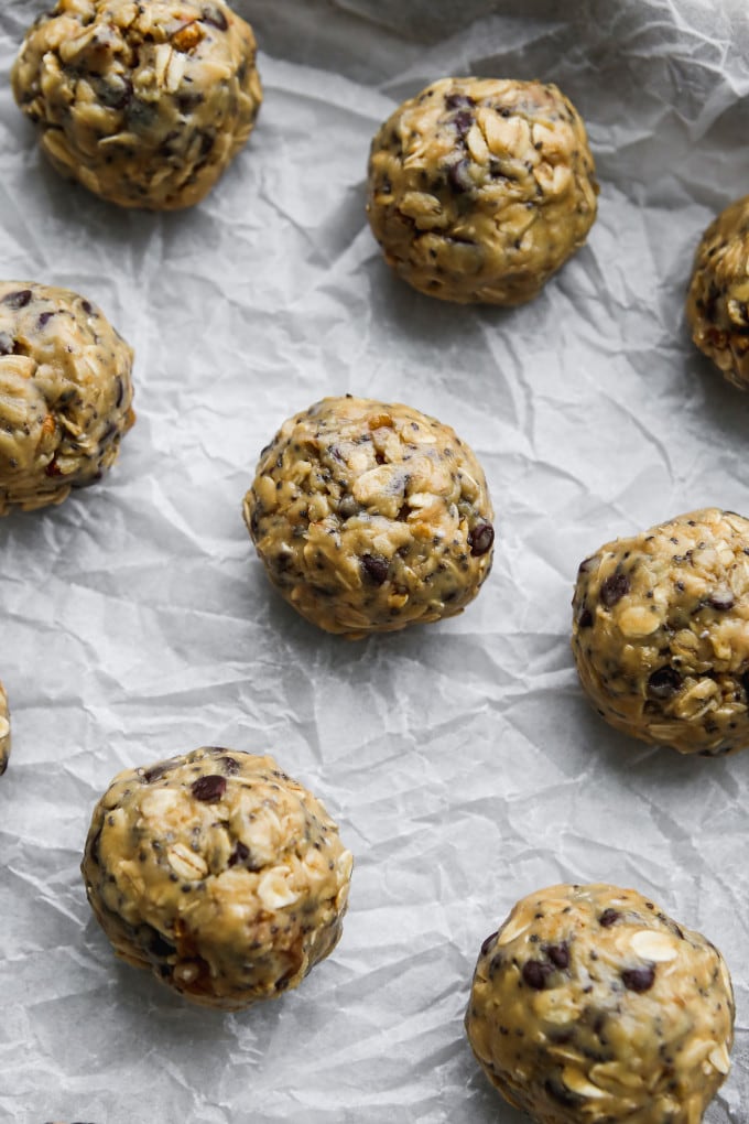 Tahini energy balls on a parchment-lined baking sheet.