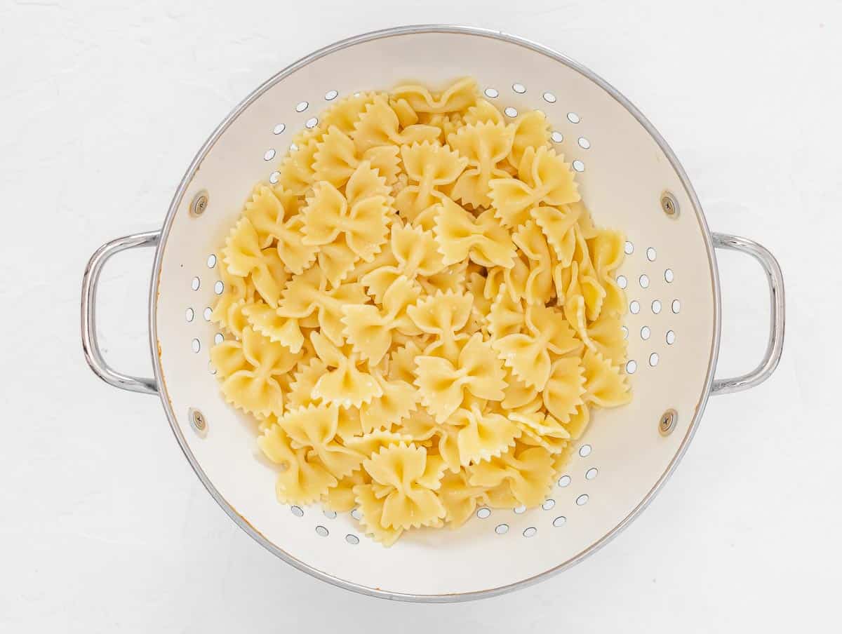 pasta in a sieve rinsed under cold water