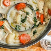a ladle in a pot of chicken gnocchi soup