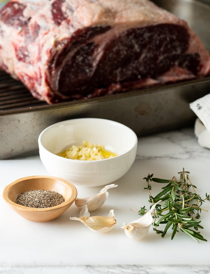 Make a garlic and herb rub to coat the outside of the standing rib roast.