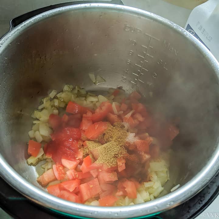 adding tomatoes and spices