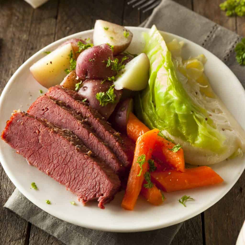 white plate holding one serving of Mom's Corned Beef and Cabbage