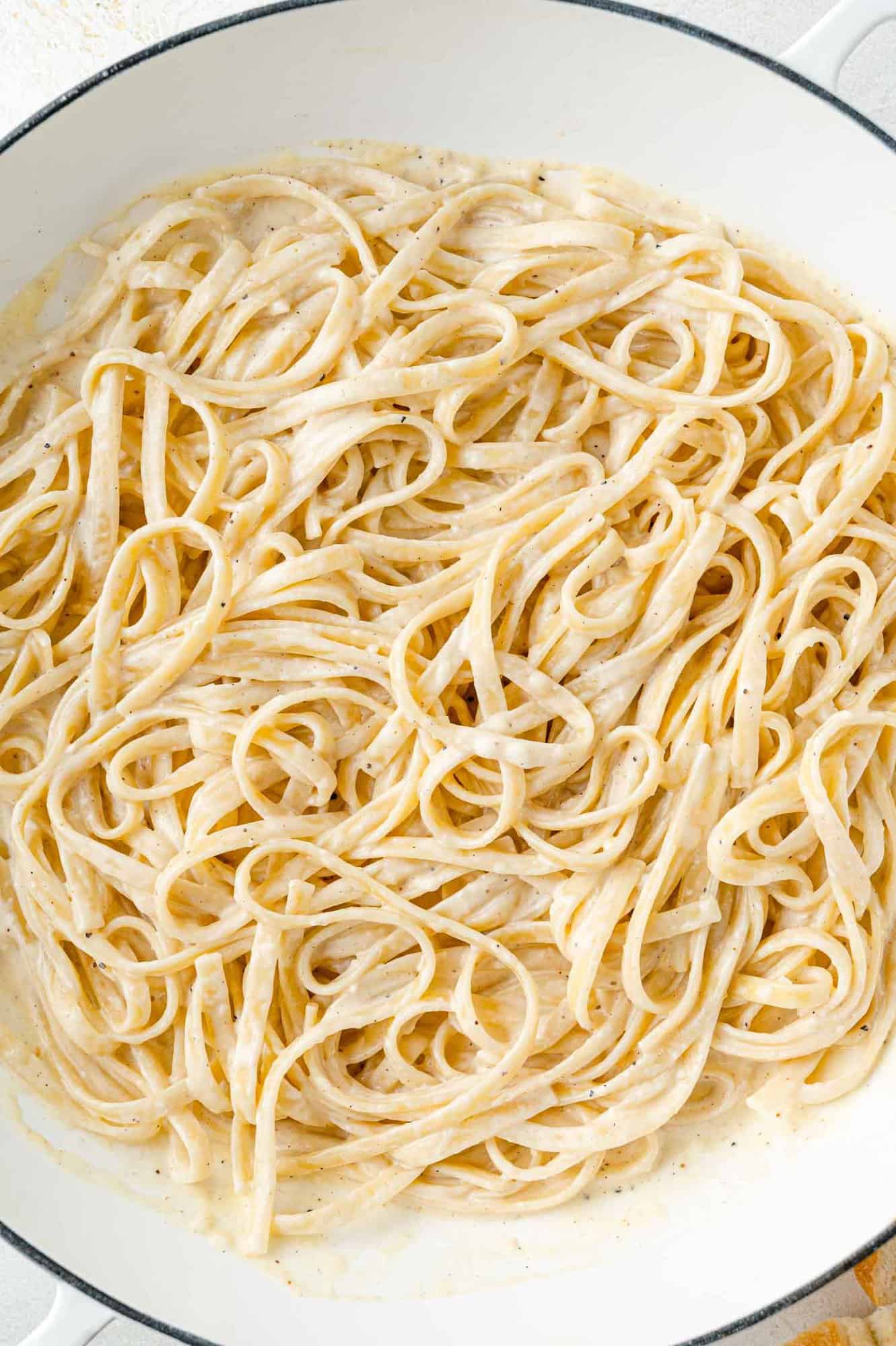 Alfredo sauce tossed with cooked fettuccini.