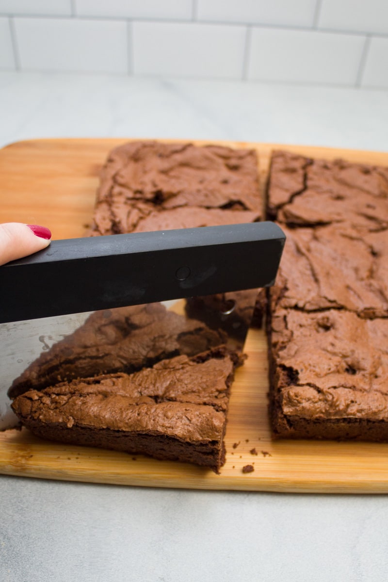 Slicing espresso chocolate chip brownies into triangles.