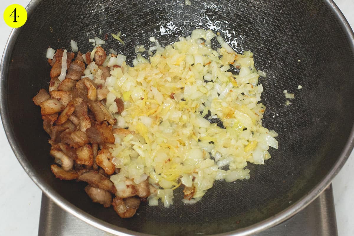 Sauteing aromatics in a wok.