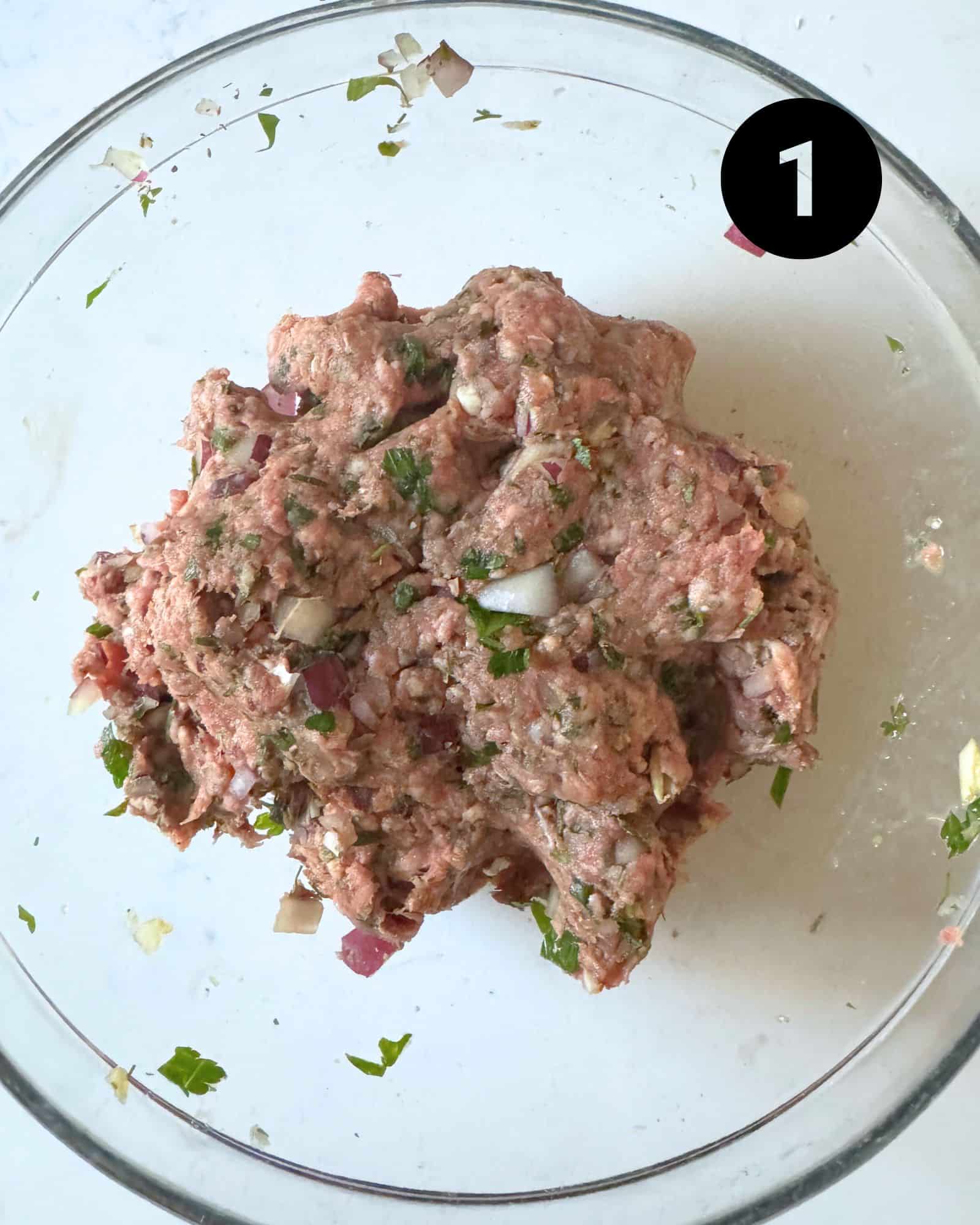 meatball ingredients mixed together in a mixing bowl.