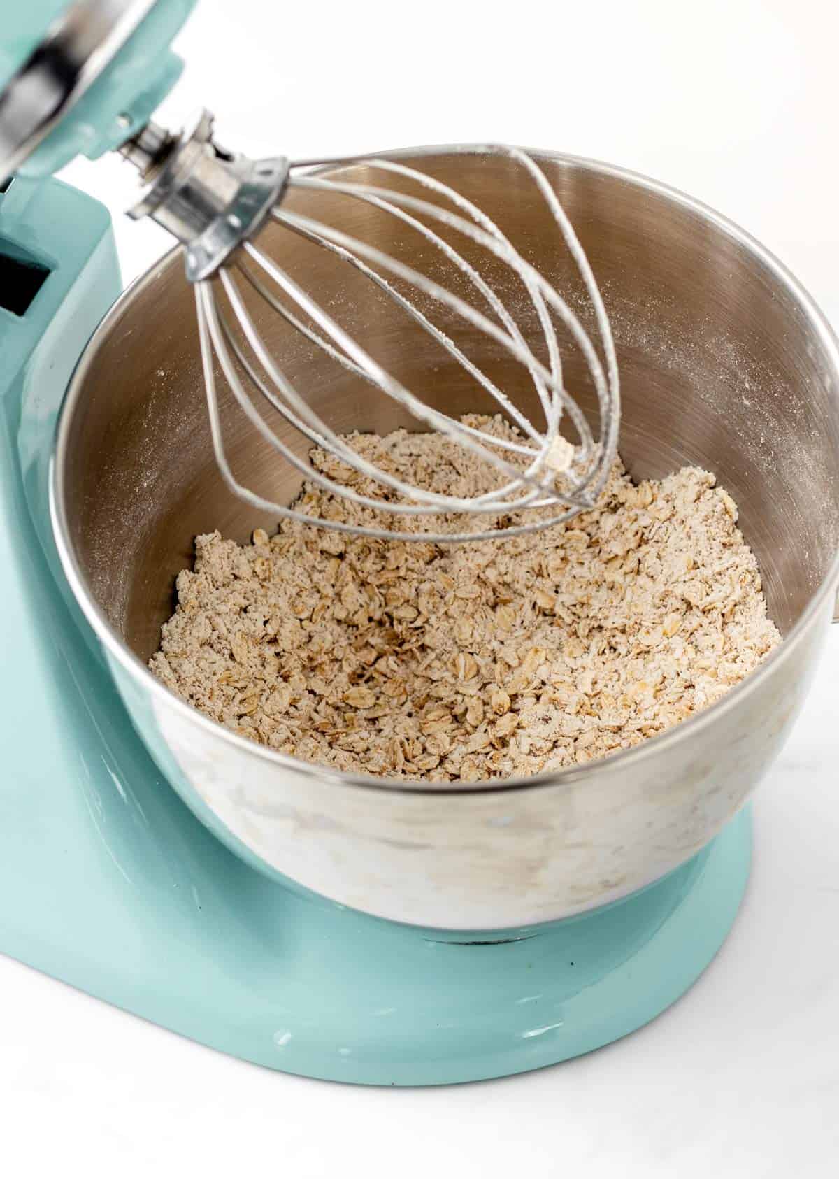 Grinding the oats in a stand mixer.