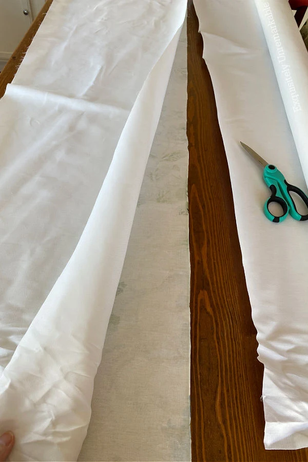 Cutting White Curtain Liner For A Valance with scissors
