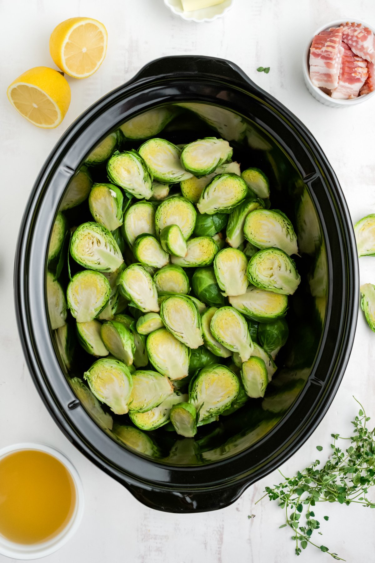 Brussels sprouts in a crockpot before cooking.