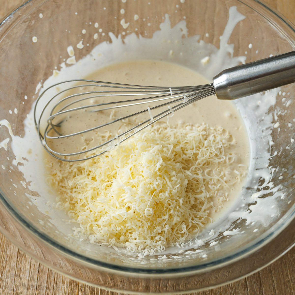 Whisking in parmesan cheese