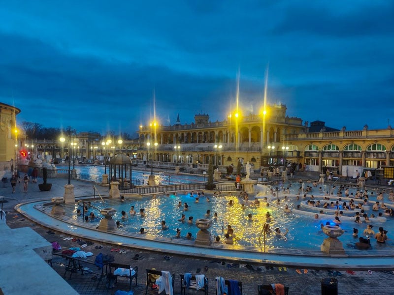 Széchenyi Baths transforms into a glowing oasis at night, offering a unique and relaxing experience.