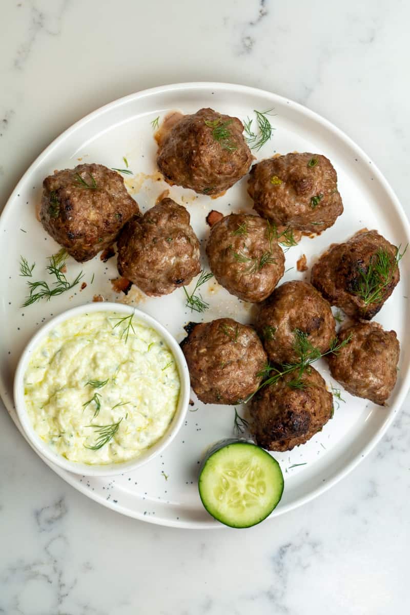 These Oven Baked Lamb Meatballs with Tzatziki is created by making a homemade tzatziki sauce and deliciously baked lamb meatballs.