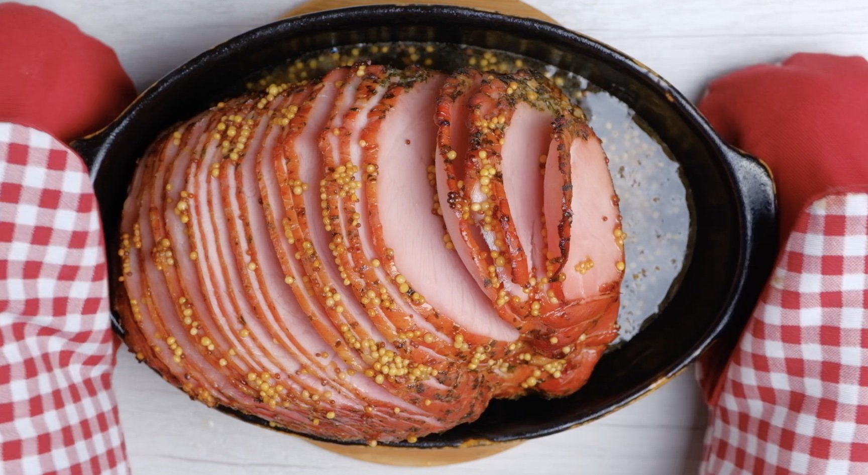 Spiral spiced ham on a dish with honey glaze on it. 