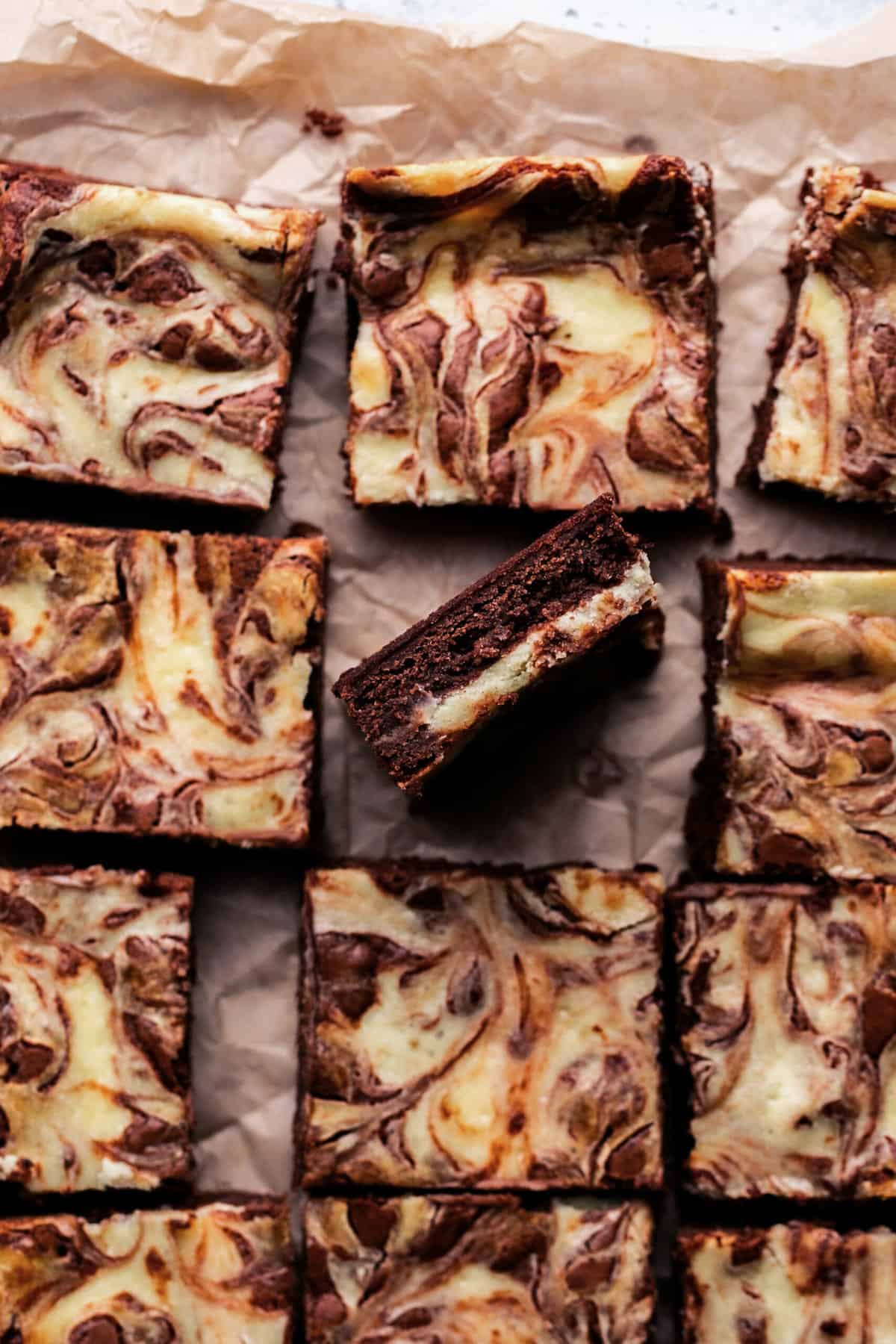 cream cheese swirled brownies on parchment paper