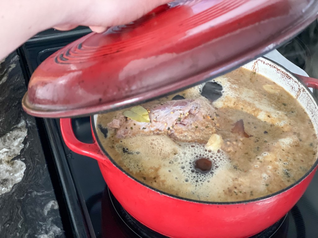 dutch oven with keto corned beef simmering over stove