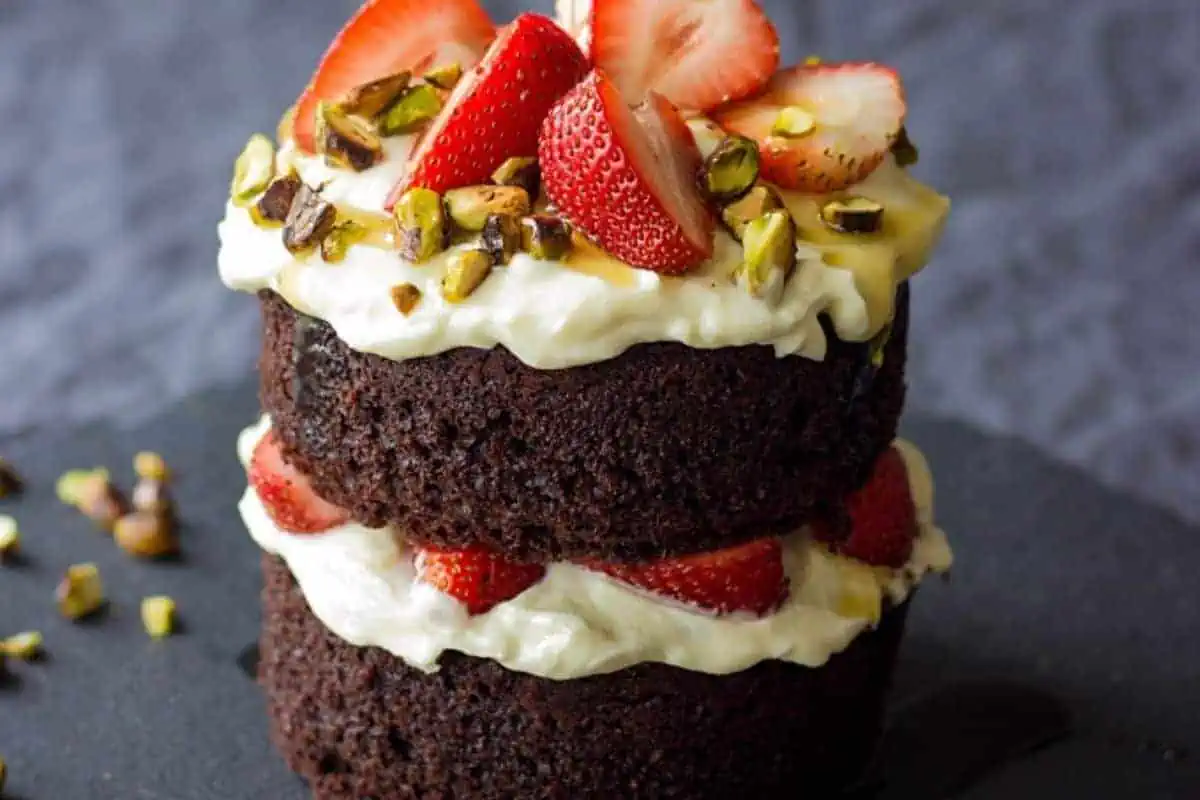 Mini chocolate cake with Mascarpone cream on a dark background.