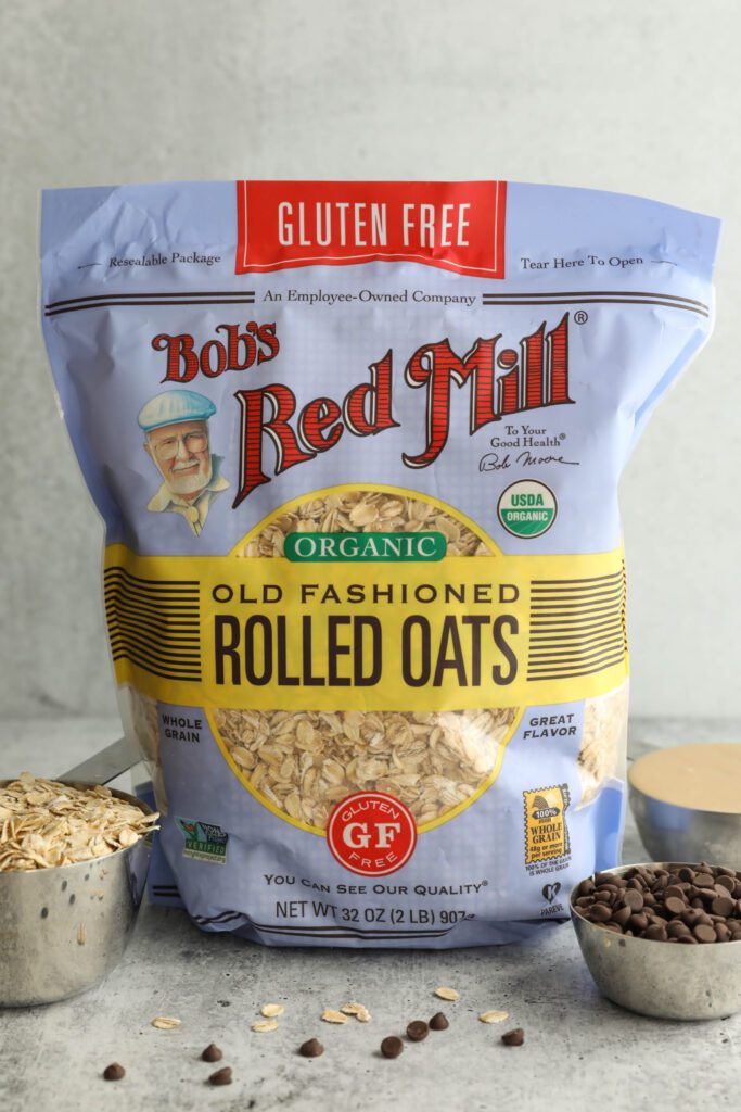 Bob's Red Mill Organic Old Fashioned Rolled Oats bag with chocolate chips, oats, and tahini in measuring cups
