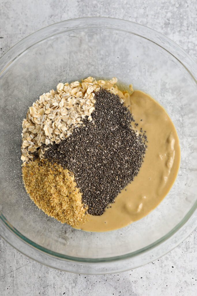 oats, tahini, ground flaxseed, and chia seeds in mixing bowl 