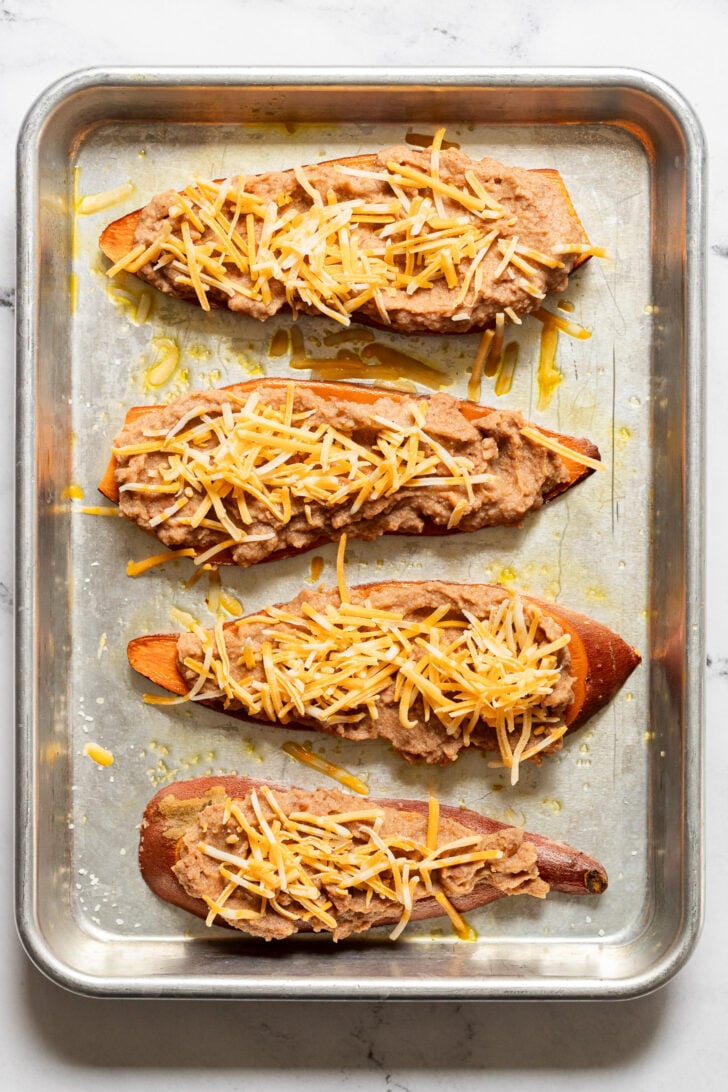 Sweet potato toast with refried beans and shredded cheese.