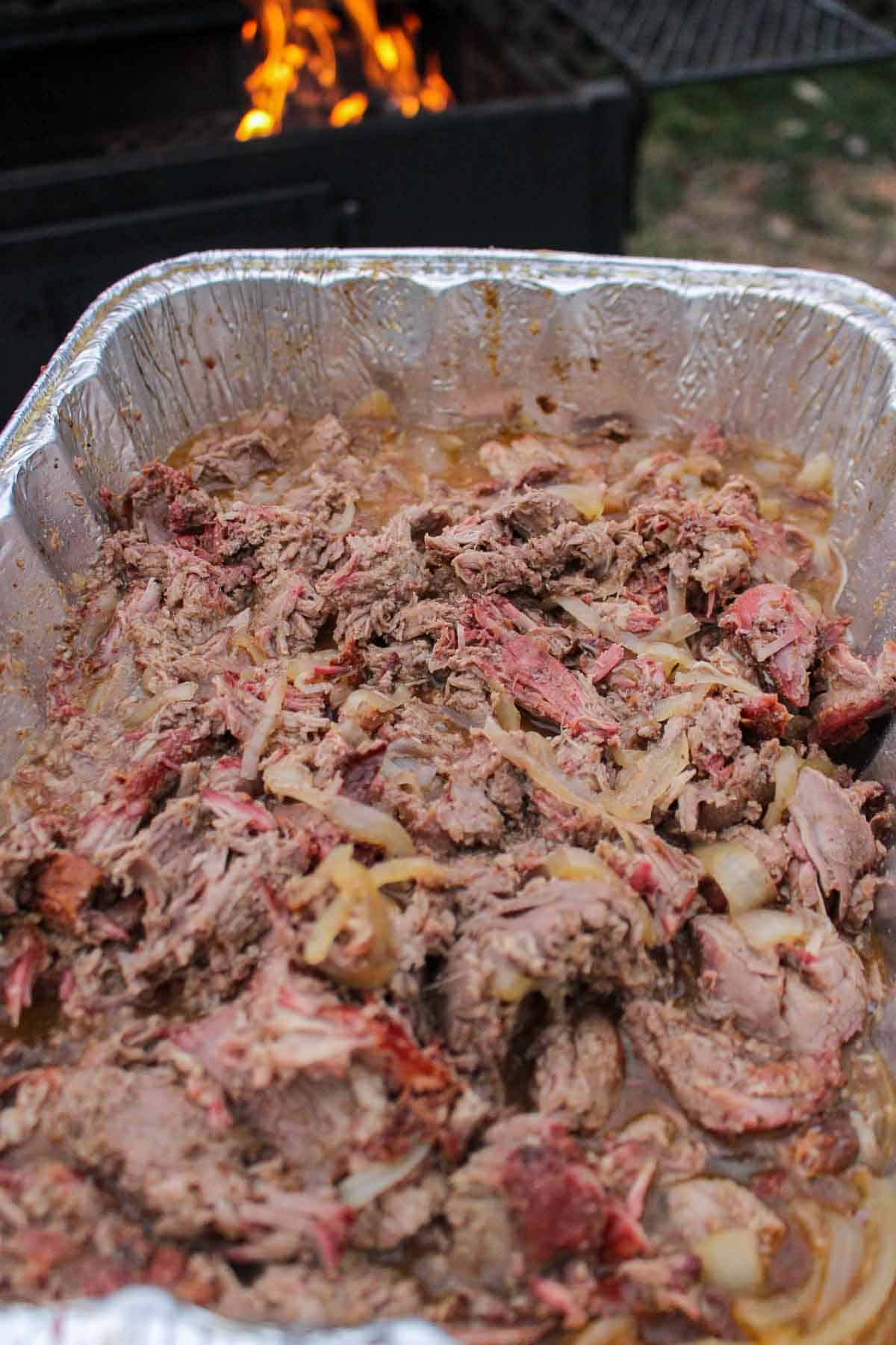 The shredded, pulled leg of lamb meat.