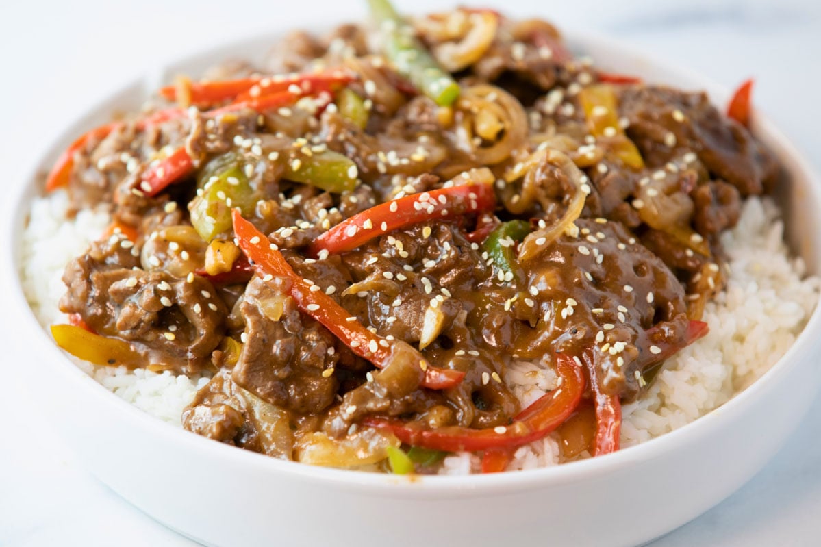 bowl of pepper steak and onions over rice