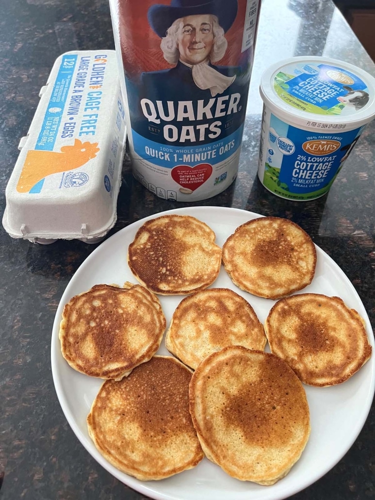 a plate of Cottage Cheese Pancakes next to eggs, oats, and cottage cheese