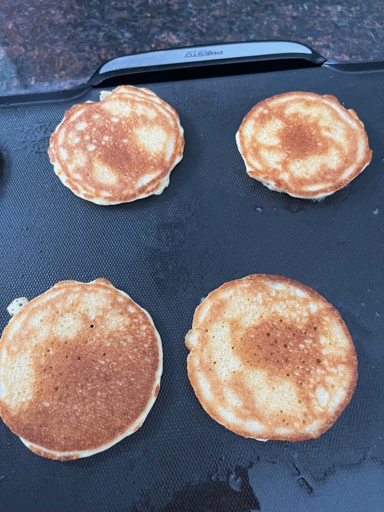 hot and fresh Cottage Cheese Pancakes on a griddle