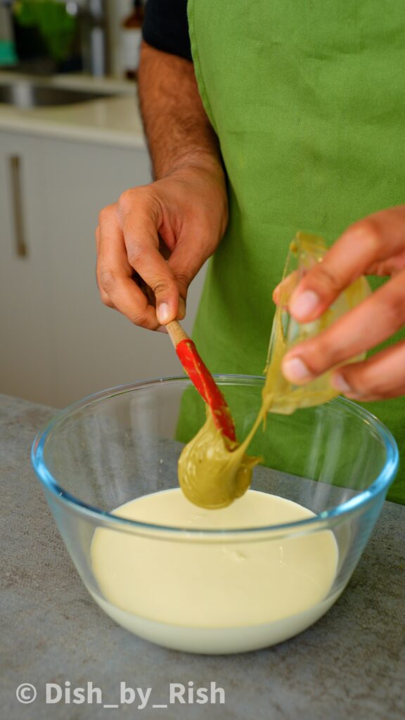 adding pistachio cream to cream