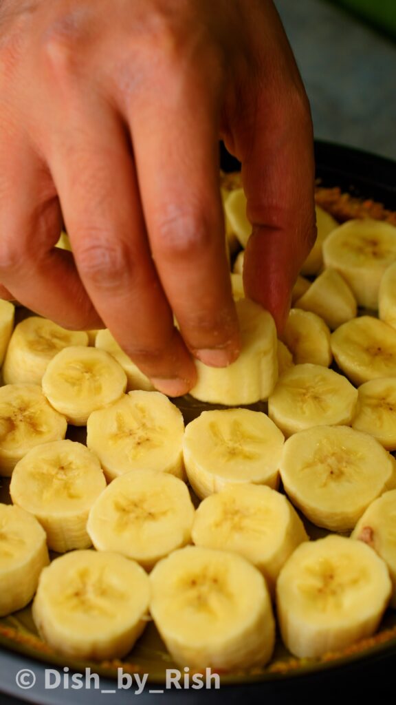 placing bananas on top of pistachio cream