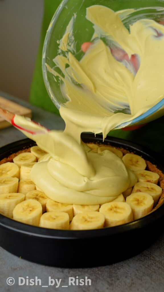 placing pistachio whipped cream over bananas