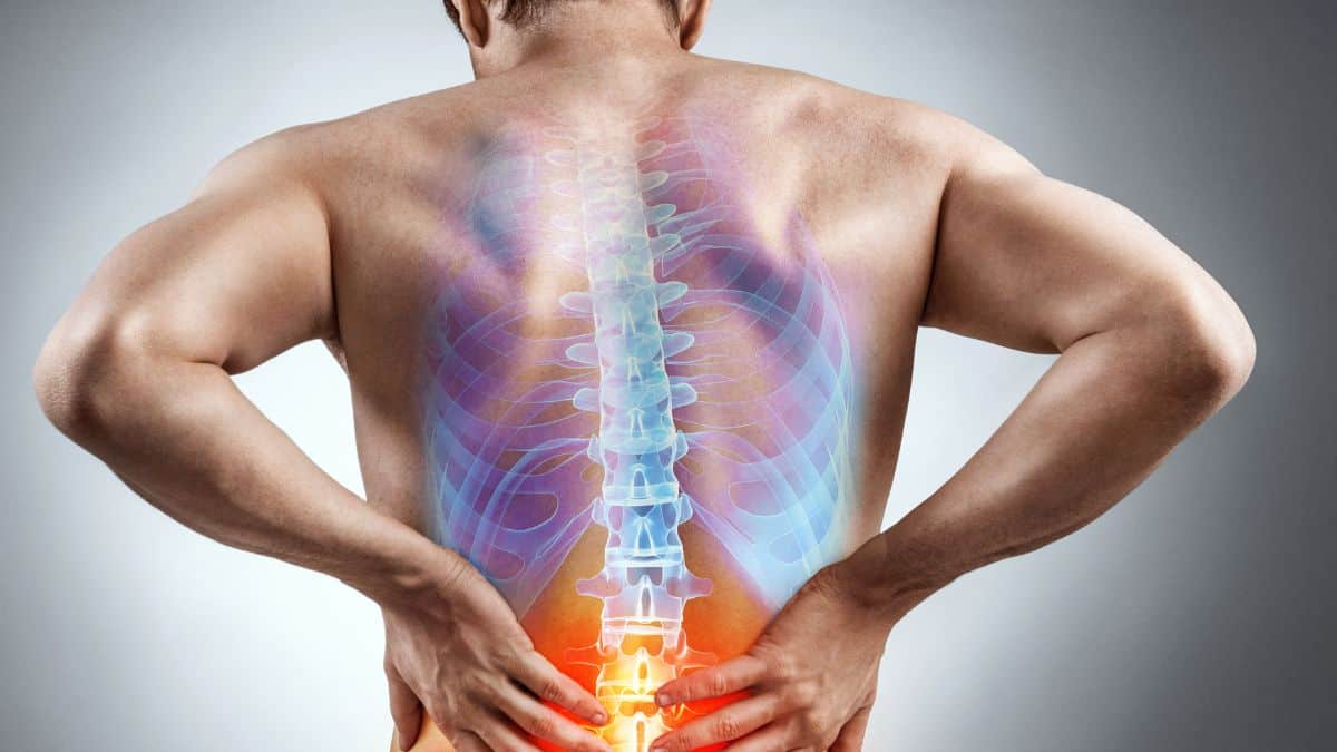 Man experiencing lower back pain with a visual representation of spine discomfort.