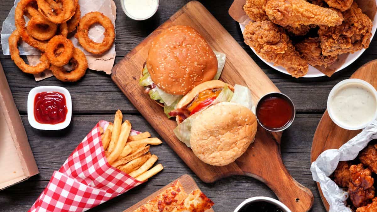 A variety of fast food items on a wooden table.