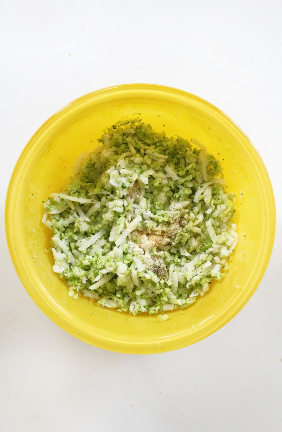 step 1 adding shredded veggies to bowl for broccoli tots.