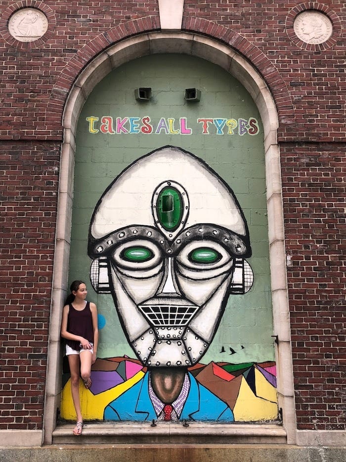 teen girl in front of street mural in Providence
