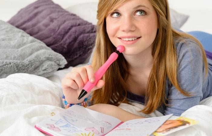 teen girl writing in journal