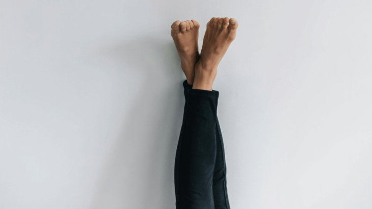 Woman lying down with her legs in Legs Up the Wall