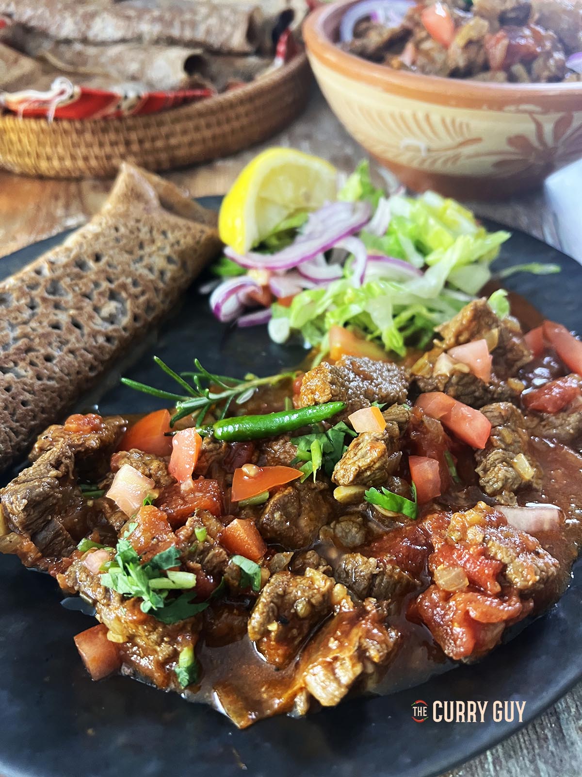 Serving the beef tibs with injere bread and salad.