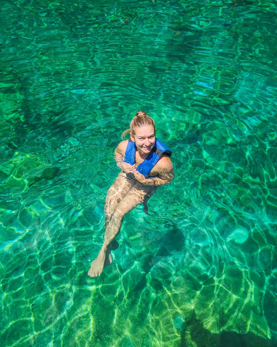 Bailey swims in a cenote in mexico