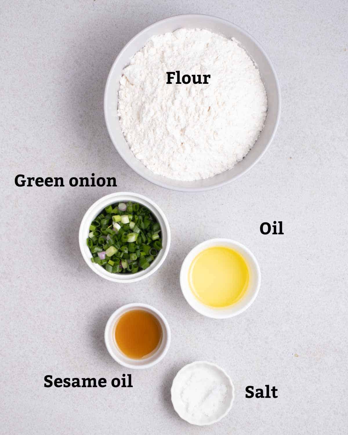 Ingredients needed like flour, green onion, oil, sesame oil, and salt.