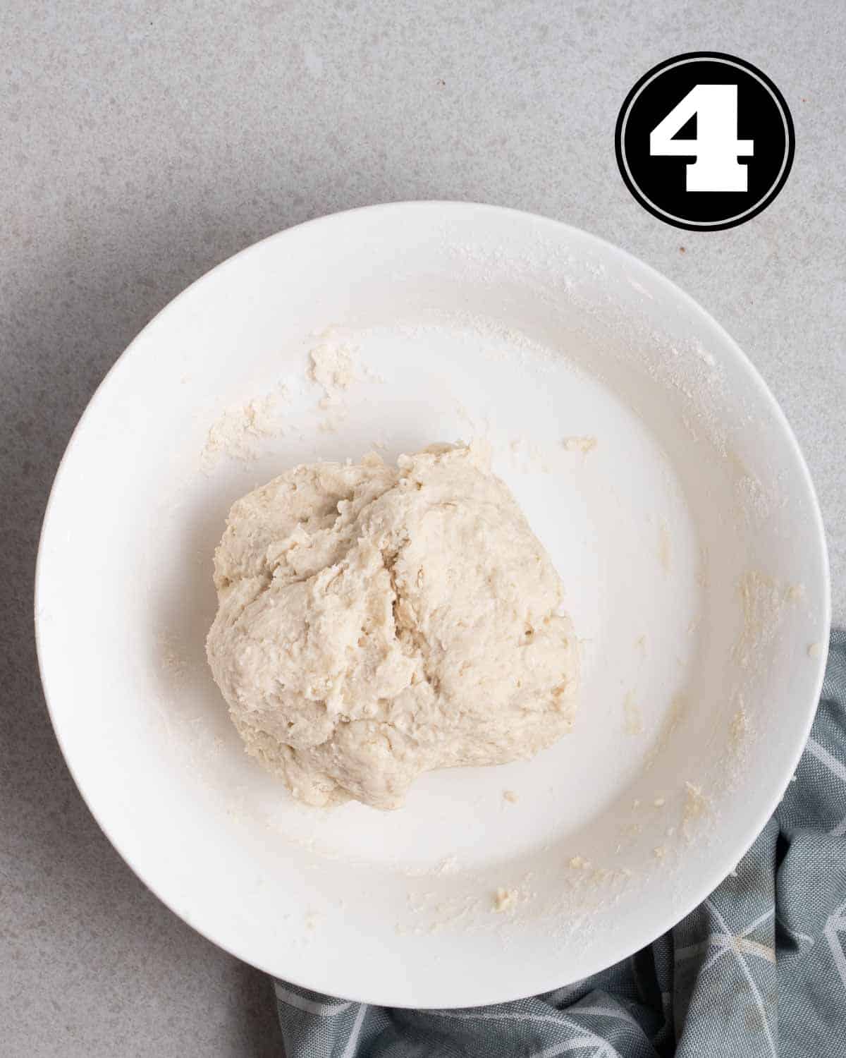 Dough of scallion pancakes in a white bowl.